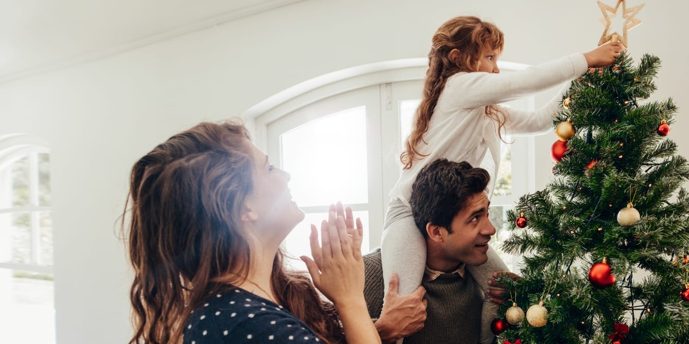 My neurodivergent daughter reminds me of the magic to be found in the holidays family decorating Christmas tree - neurodivergent daughter