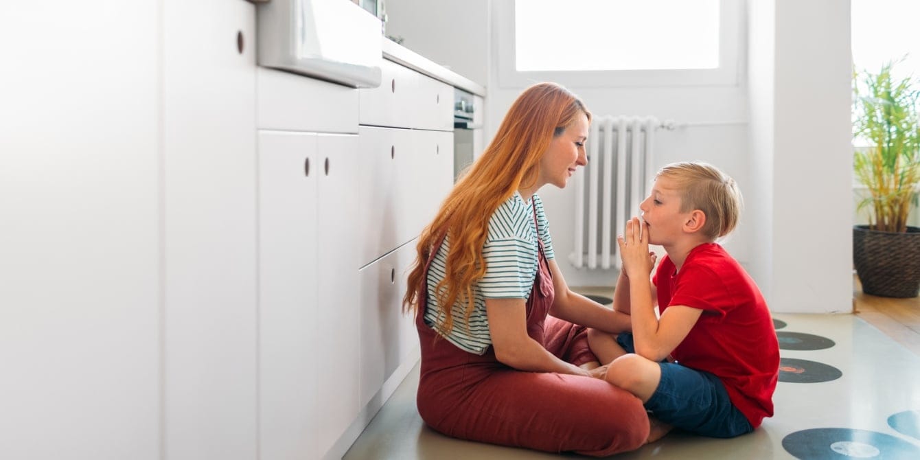 The power of words: Why non-physical compliments mean so much more to children (and adults) mother and son sitting on kitchen floor talking non-physical compliments
