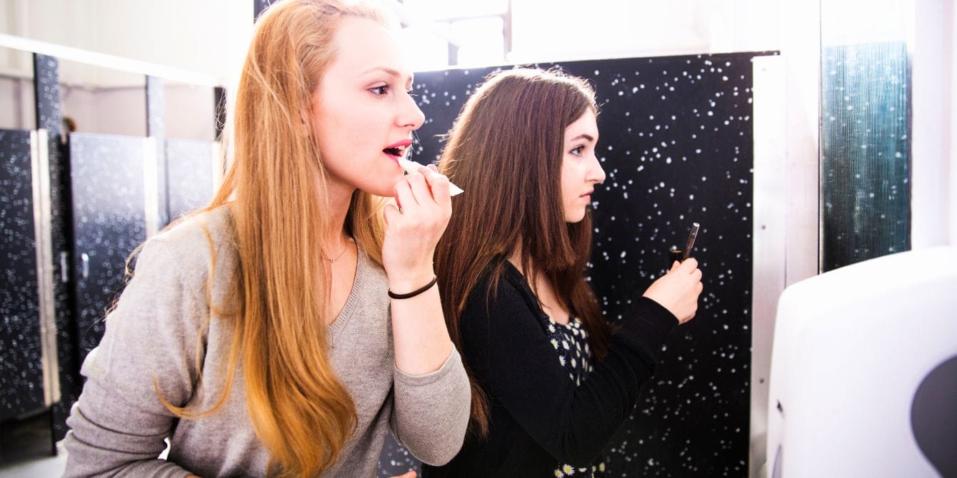 School removes mirrors from bathrooms to curb students’ TikTok use Teen girls using school bathroom mirror