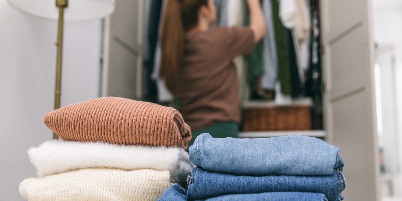What we need changes: Why I keep a stack of jeans in the back of my closet woman cleaning out closet - what we need changes