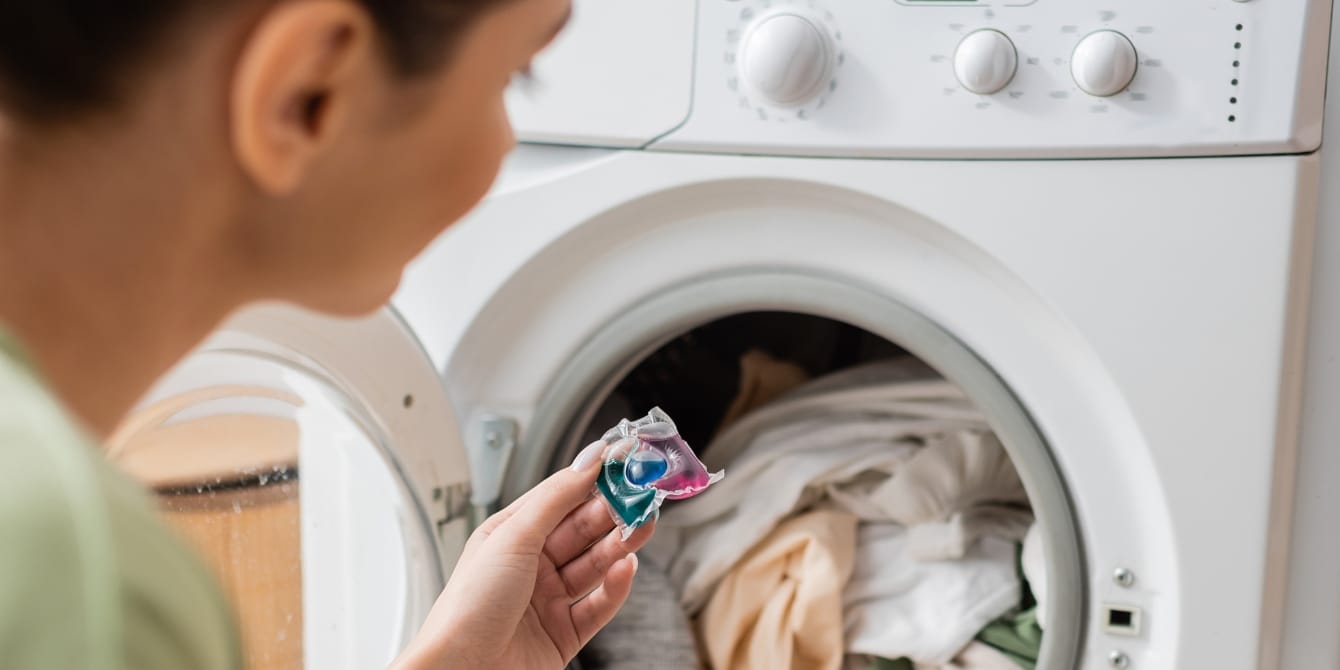 Poison control center data shows the number of kids and older adults exposed to laundry pods is still high woman putting laundry pod in washer
