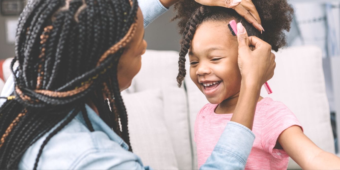 Black women react to sweet viral video that shows why Black hair should be celebrated Black mother fixing her daughter's hair