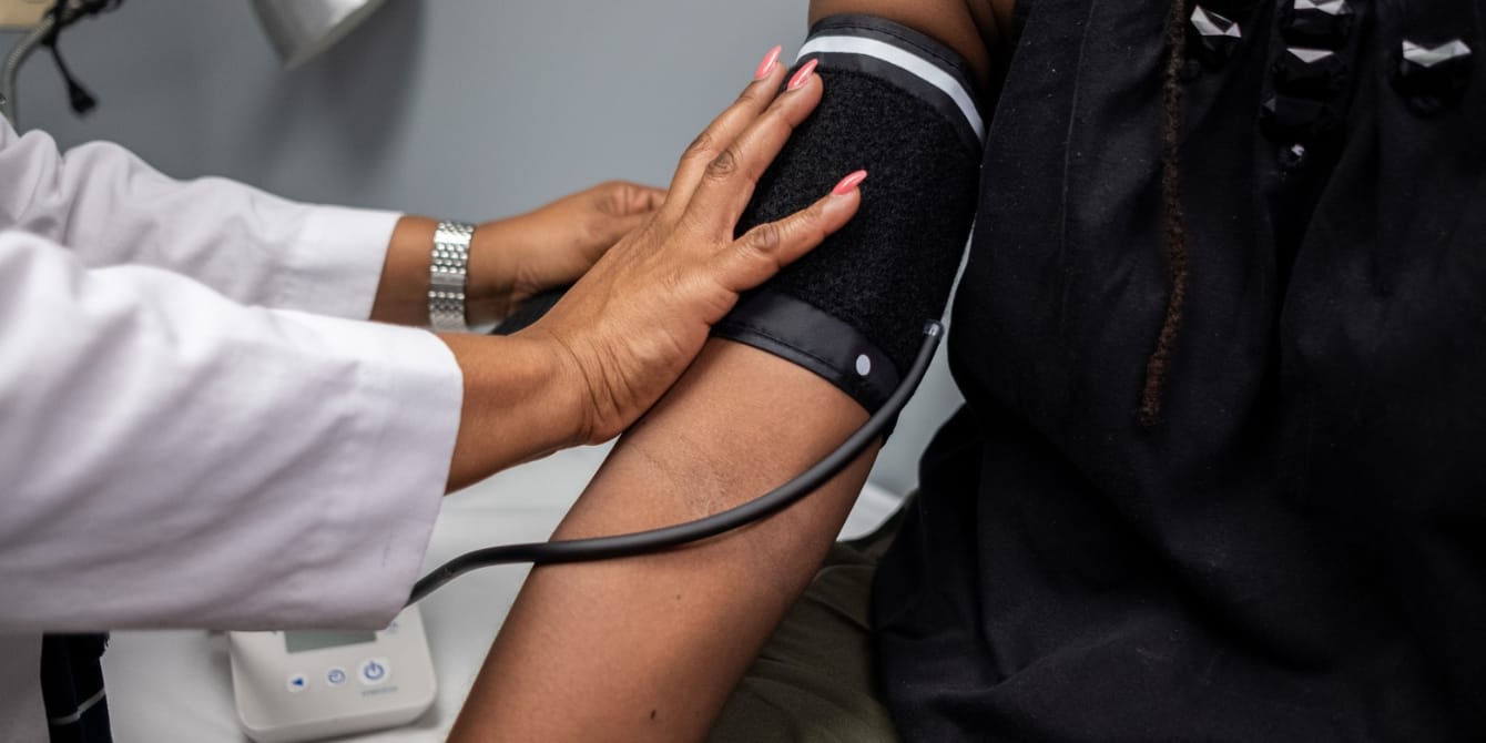 Black women are often left out of clinical trial research. Here’s what we can do to change that Black women blood pressure check - often left out of clinical trial research