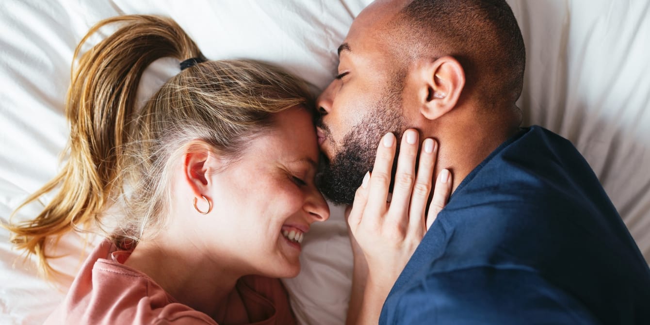 6 ways to strengthen your relationship while going through fertility challenges couple cuddling together in bed infertility