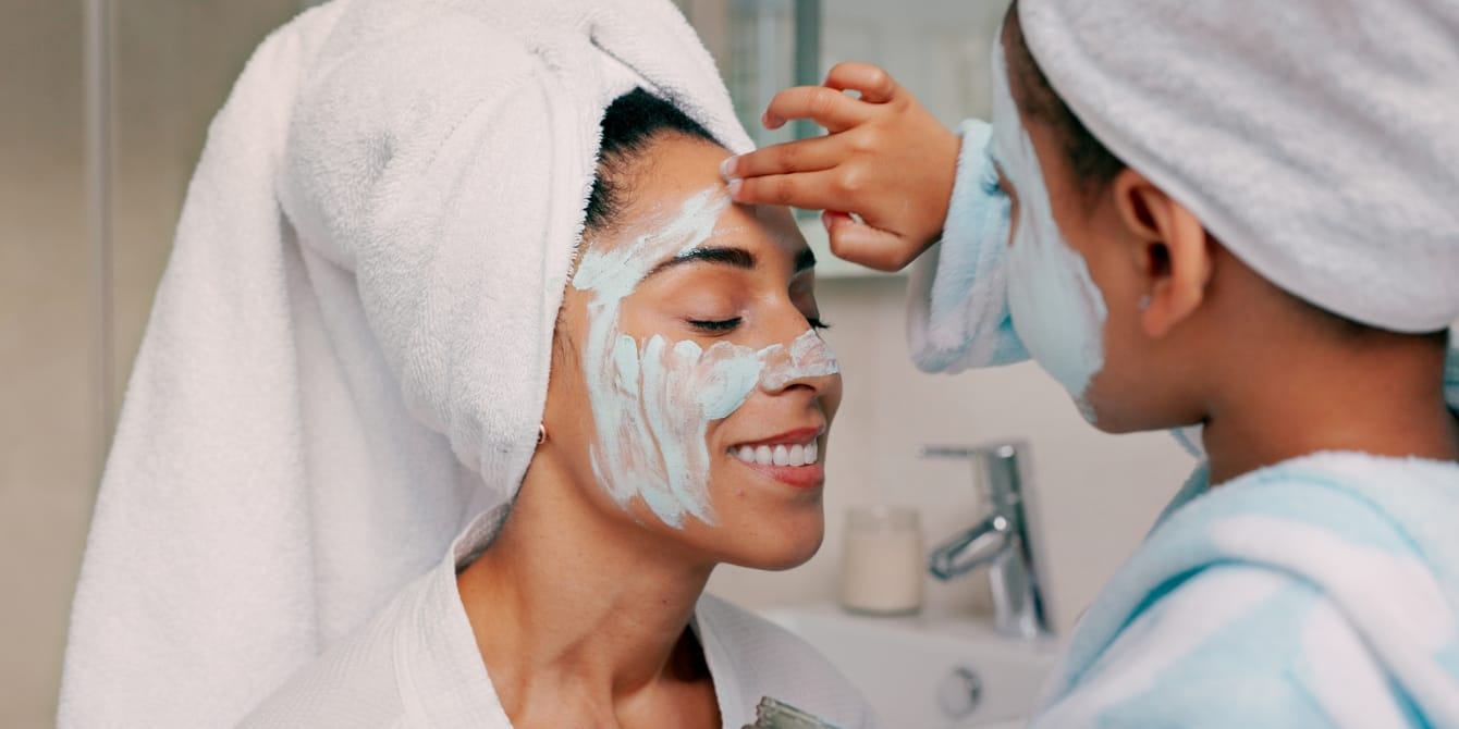 Childhood is making magic out of everyday rituals mom and daughter with towels on and doing masks- childhood memories