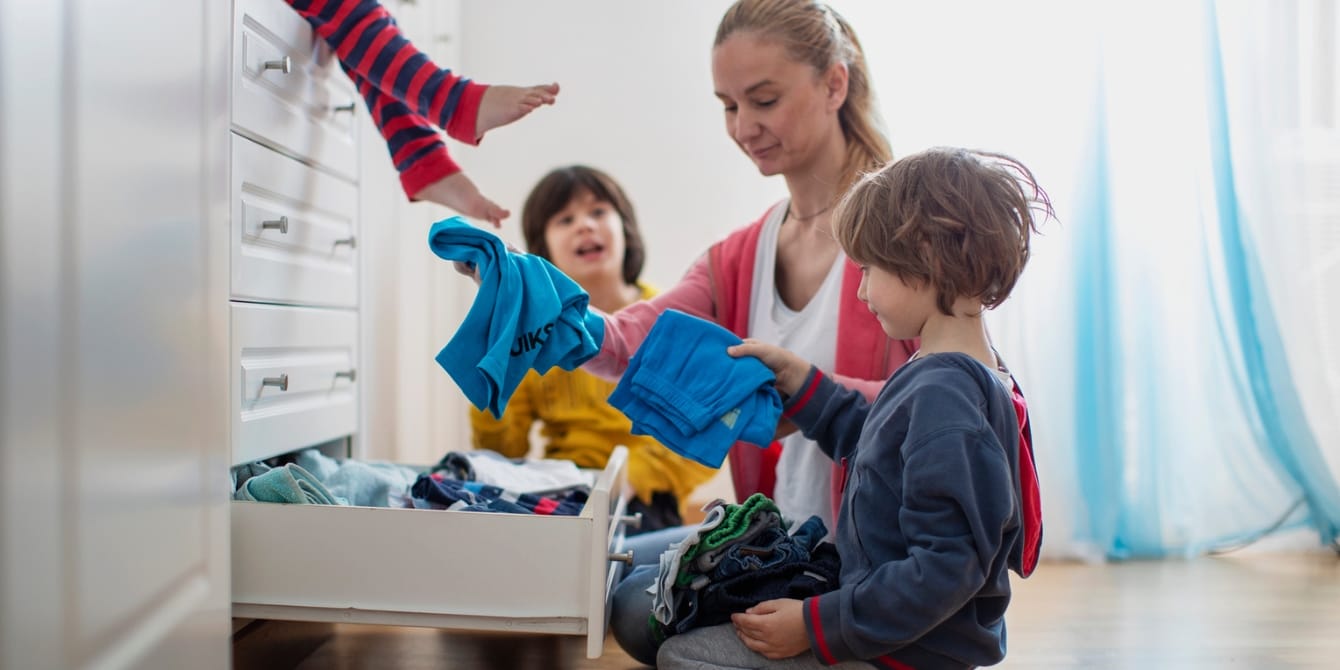 Housework is never ending—but that doesn’t mean your work is housework is never ending- mom and kids putting clothes away