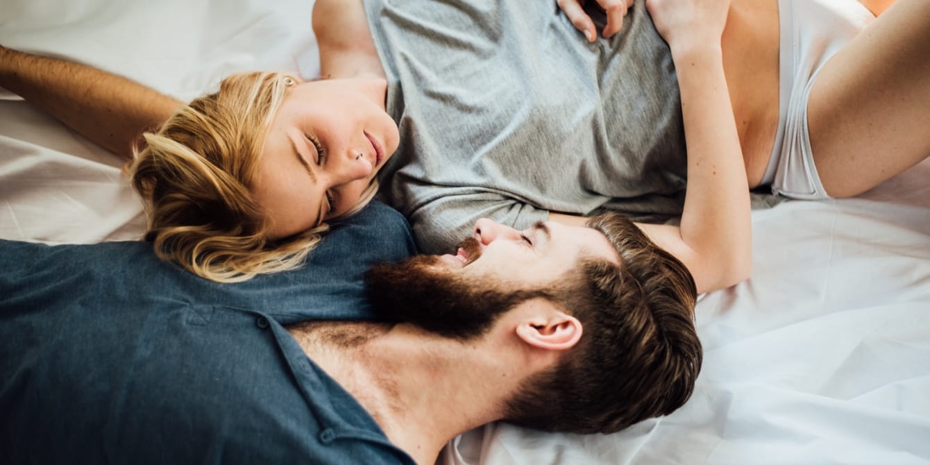 Want to have more sex after kids? Try these 3 strategies couple laying in bed together more sex after kids