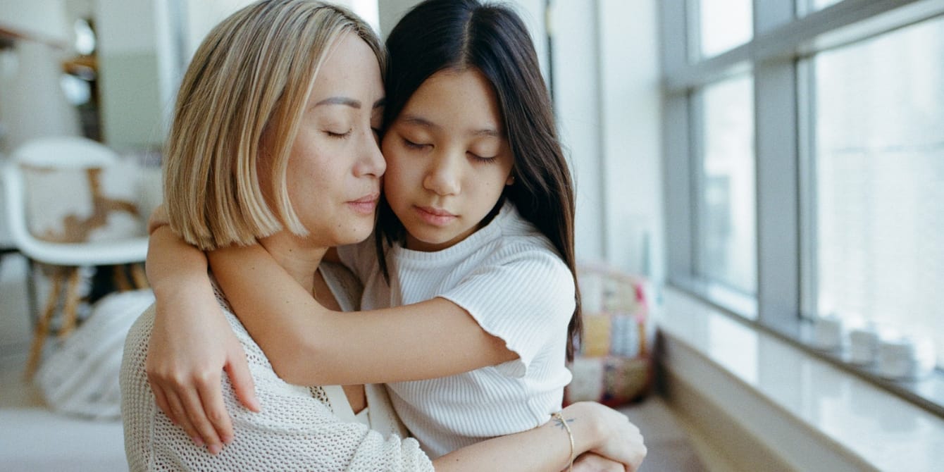 How to talk about death with kids: 8 tips to make the uncomfortable more manageable emotional mother and young daughter hugging