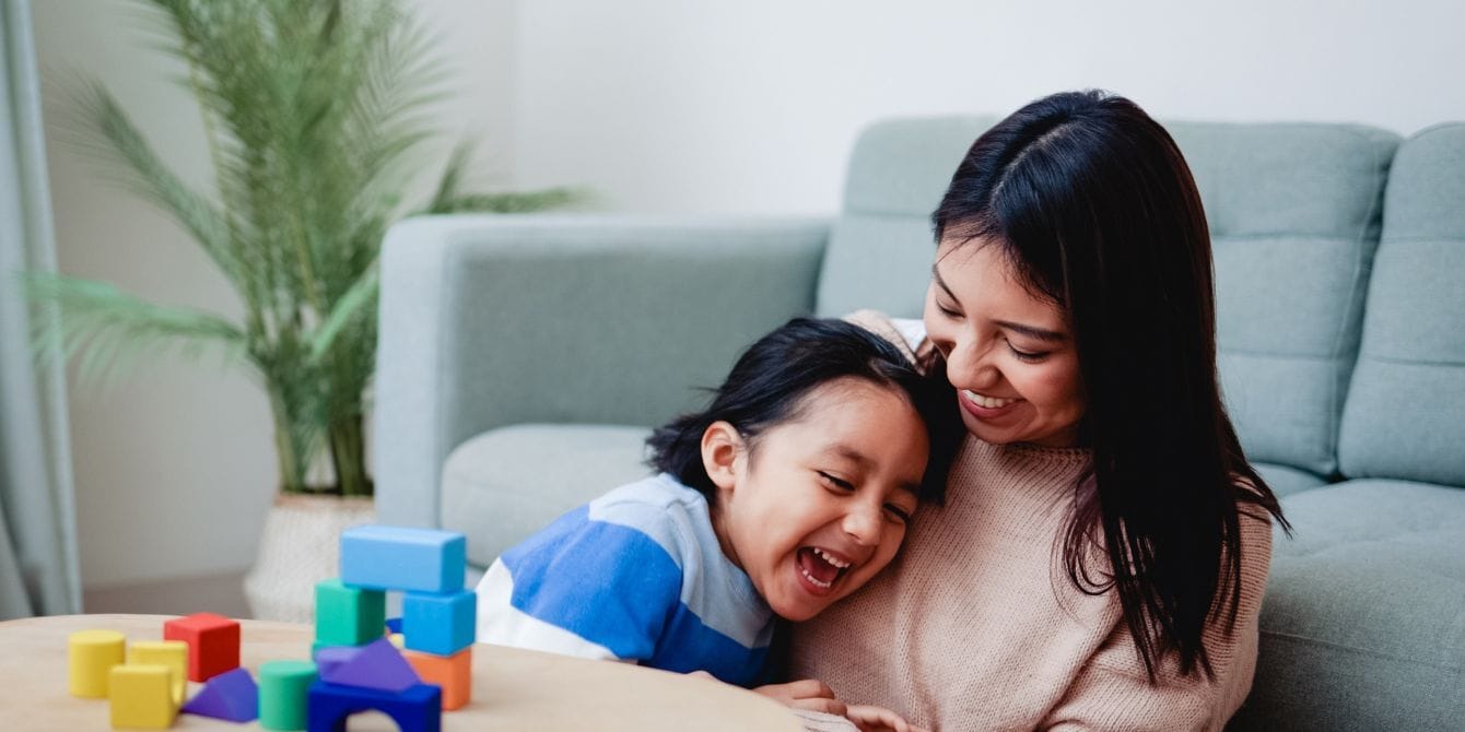 5 steps to starting Montessori at home—no perfect playroom required mom playing blocks with child starting montessori at home