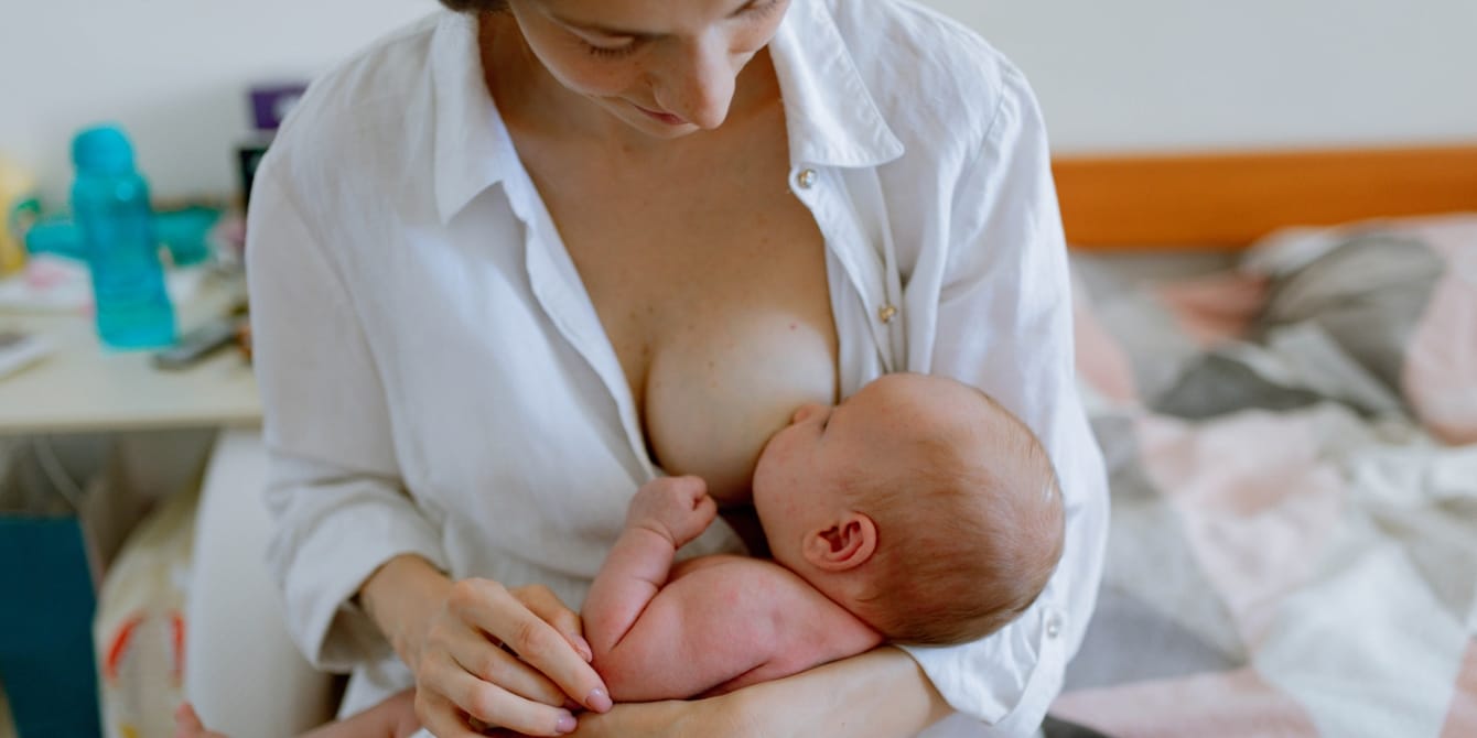 mother breastfeeding her baby - Motherly
