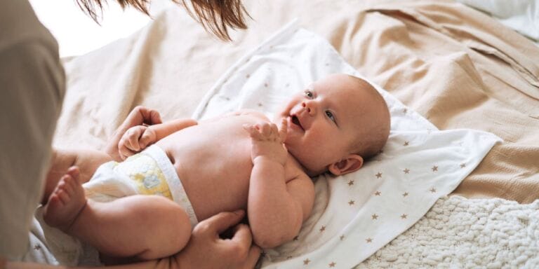 Tennessee is the first state to cover up to 100 free diapers a month for children under 2 Mom changing baby's diaper