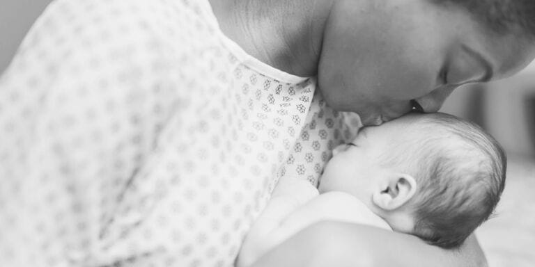 The U.S. maternal mortality rate is shockingly high—can improved midwife accessibility help? Black mother in hospital gown kissing baby