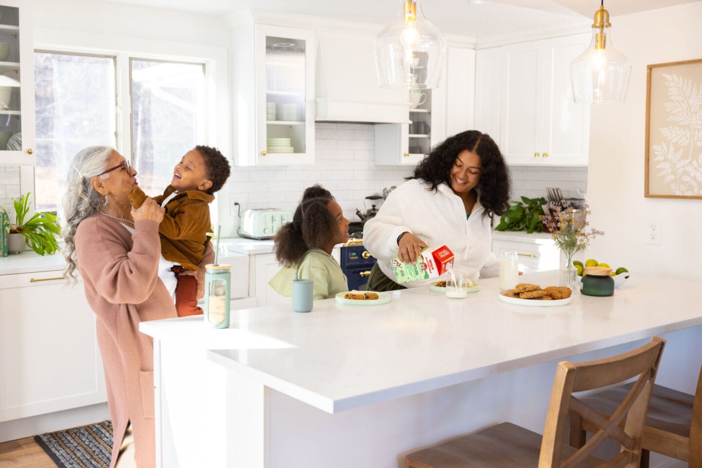 Easy ways to support your family’s brain health with Organic Valley® Family First™ Family gathered in kitchen - Organic Valley Family First Milk