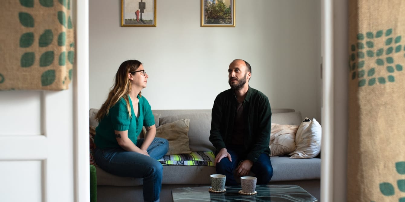 Effective communication requires good listening: Here’s the key to improving ALL your relationships couple talking and sitting on couch - how to listen