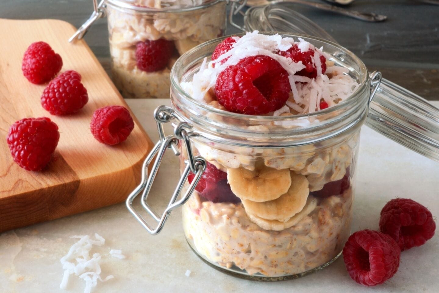 overnight oats raspberries in glass jars - Motherly