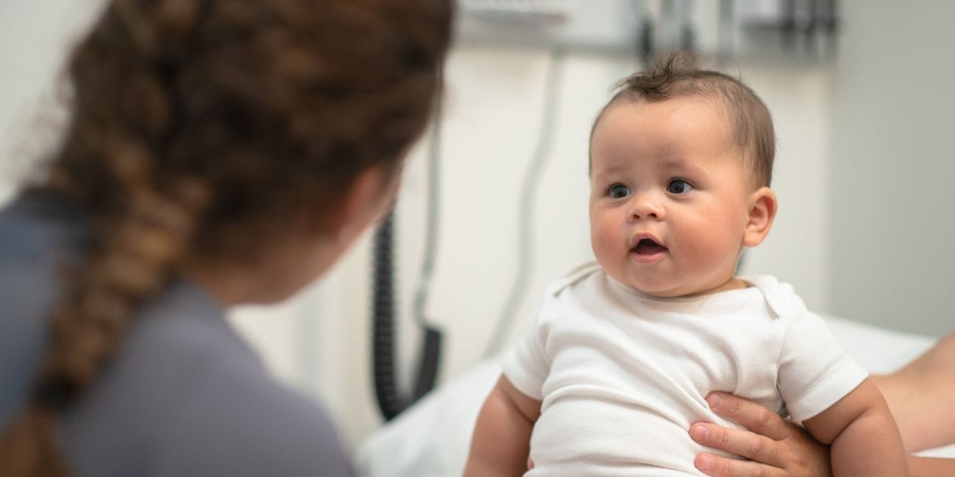 Why is there no universal screening test for CMV? baby in doctor's office - universal screening test for cmv
