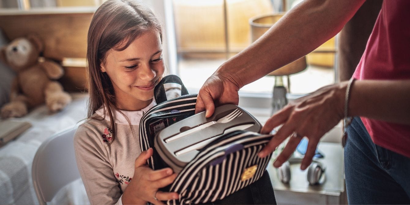 8 nutritionist-approved kids lunch ideas—that aren’t sandwiches mom packing kids lunch in backpack - non-sandwich lunch ideas for kids