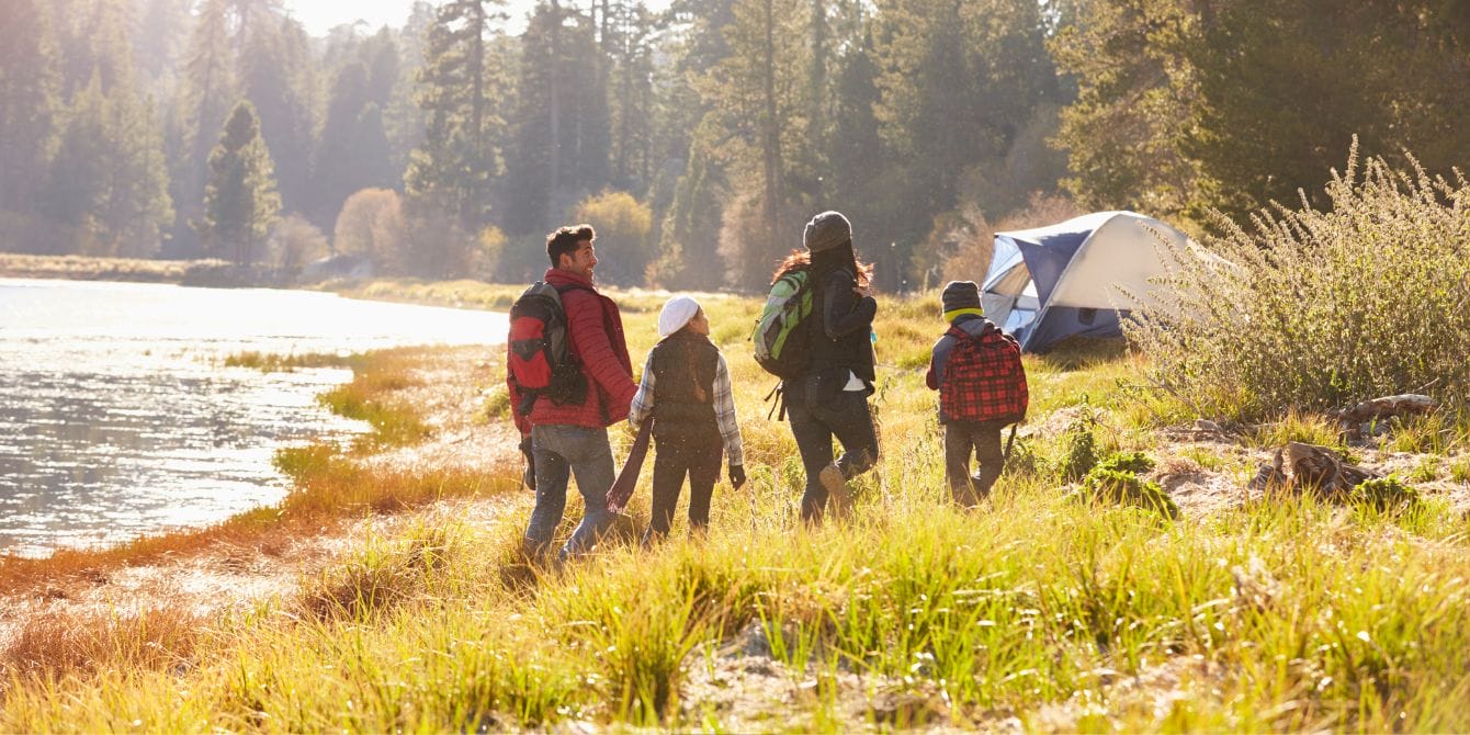 Affordable weekend getaways for families affordable weekend getaways- family walking to campsite