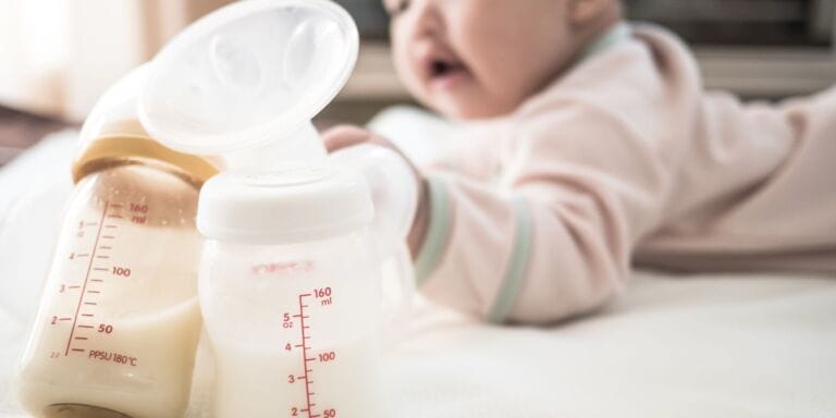 Donating breast milk saves lives—and is easier than you might think baby next to pumped breast milk - donating breast milk