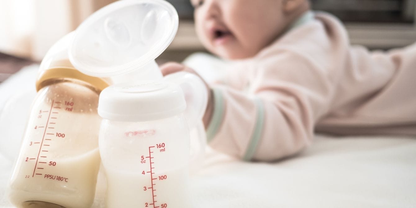 Donating breast milk saves lives—and is easier than you might think baby next to pumped breast milk - donating breast milk