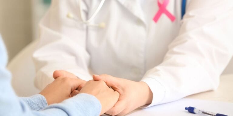 This little-known side effect impacts nearly 30% of women after breast cancer woman holding doctor's hands - lymphedema