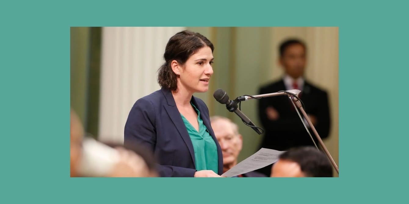 a woman speaking into a microphone