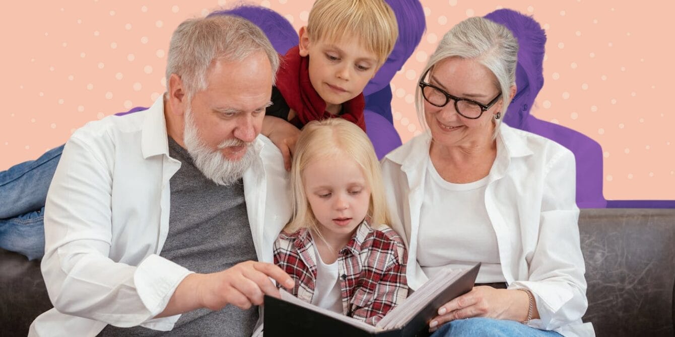 Grandparents reading story to grandchildren while all snuggled on couch together