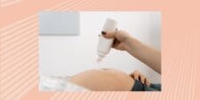 Close-up of doctor's hand putting gel on pregnant woman's belly to prepare for ultrasound