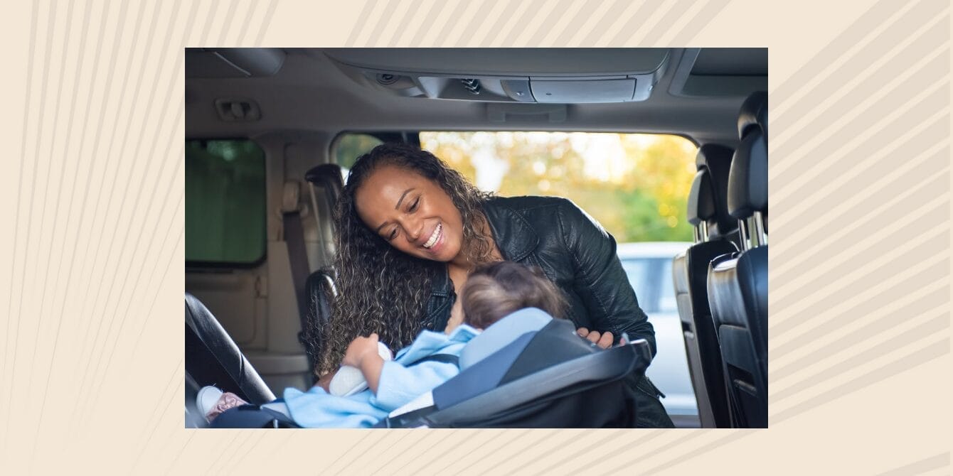 Managing the 5:00 pm to 7:00 pm time crunch Mom buckling baby into car seat and smiling