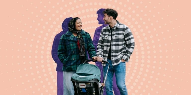 Couple taking a walk while pushing baby stroller in front of them